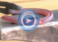 jacob Manning forges a shoe with clips.