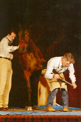 Burney Chapman works on a horse on stage at the AFA convention