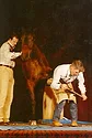 Burney Chapman works on a horse on stage at the AFA convention