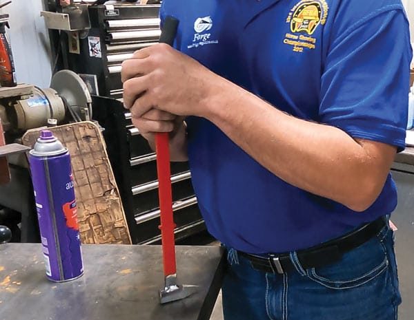 Farrier Justin Fry places grip on tool handle
