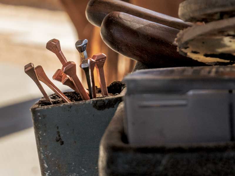 Close up of a variety of horseshoes nails in a farrier's cart.
