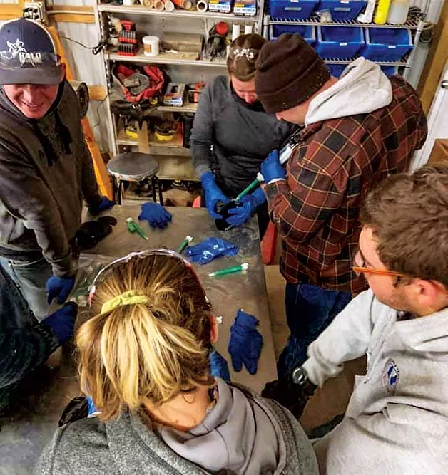 Group of farrier students participate in a product demonstration.